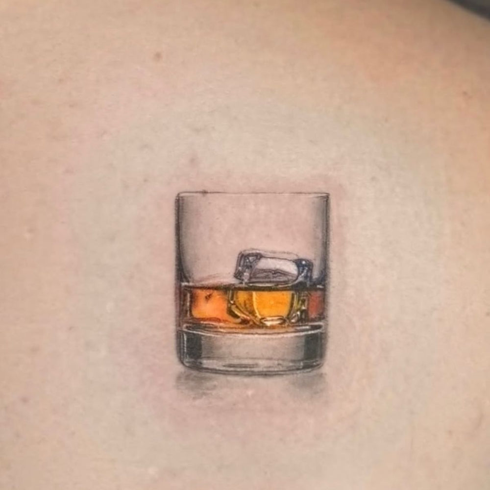 Realism tattoo of Whisky in a glass