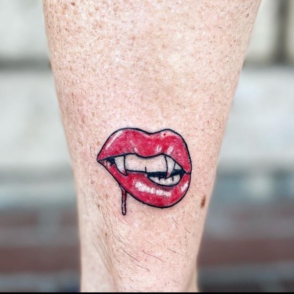 Vampire Biting Lips Tattoo